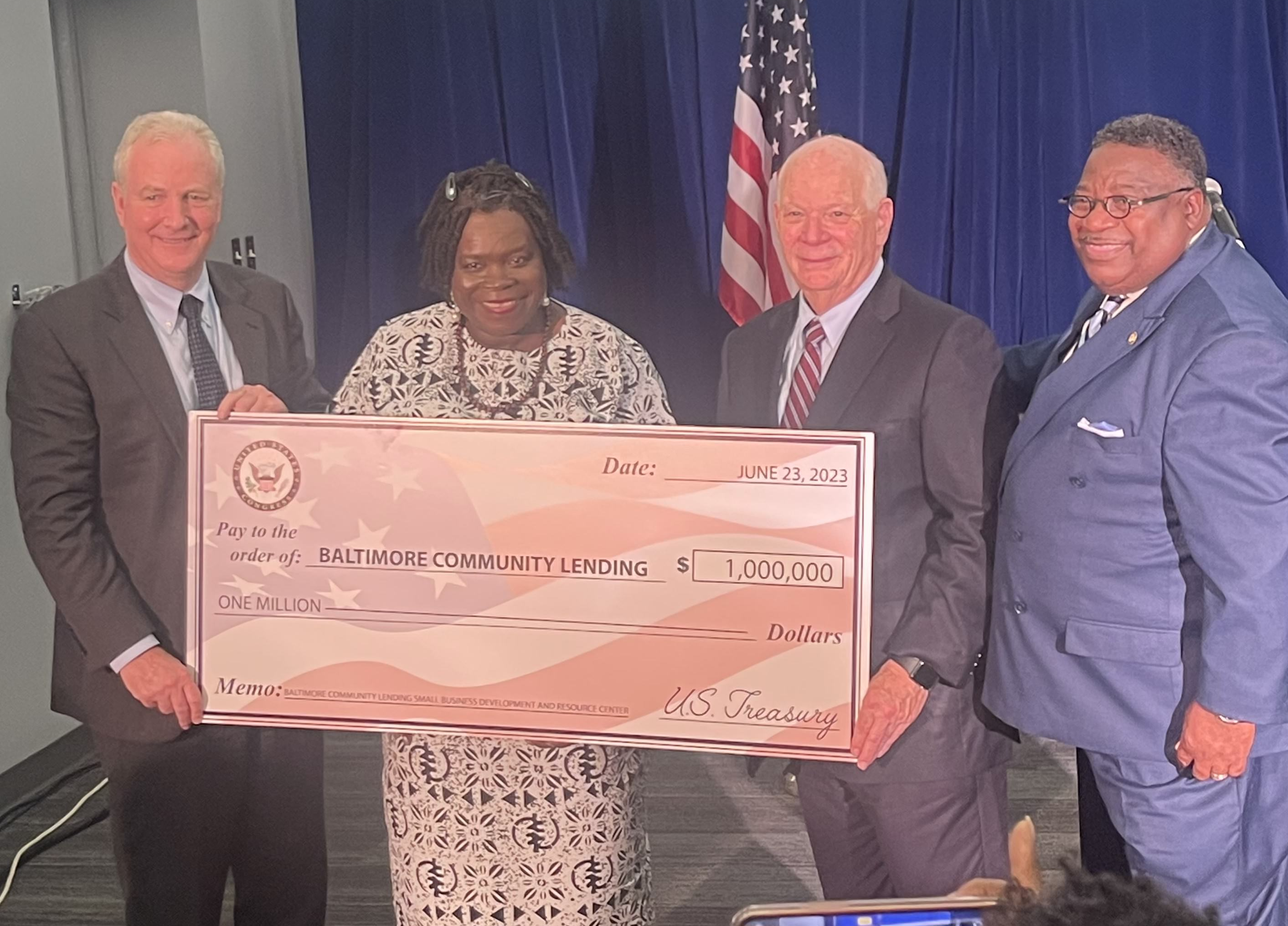 U.S. Senator Chris Van Hollen, Watchen Bruce, U.S. Senator Ben Cardin, and Jerome Stephens pose with a $1 million check.