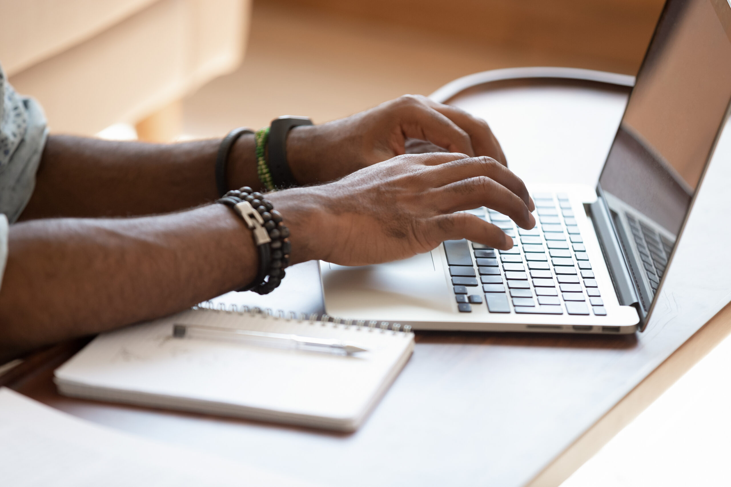 Close,Up,Cropped,Image,Young,Black,Man,Using,Laptop,At